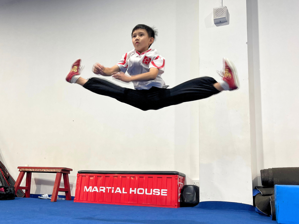 Athlete practising jumping techniques in the Wushu Jump Class at Martial House