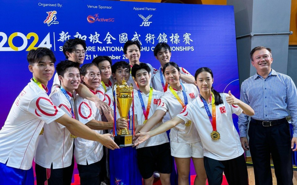 Chen Xin Yue and her teammates with the Overall Champion trophy at the Singapore National Wushu Championships 2024